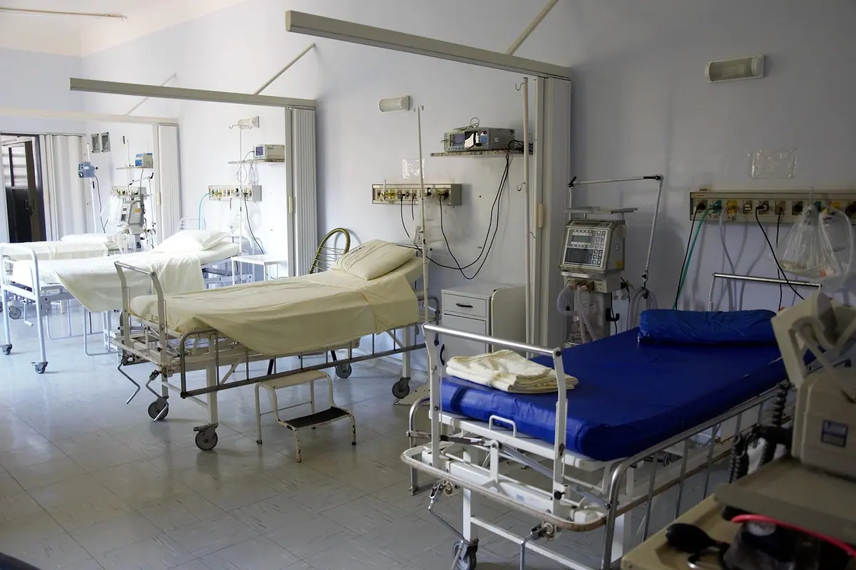 Salon de spital cu paturi și aparate, într-o încăpere luminoasă